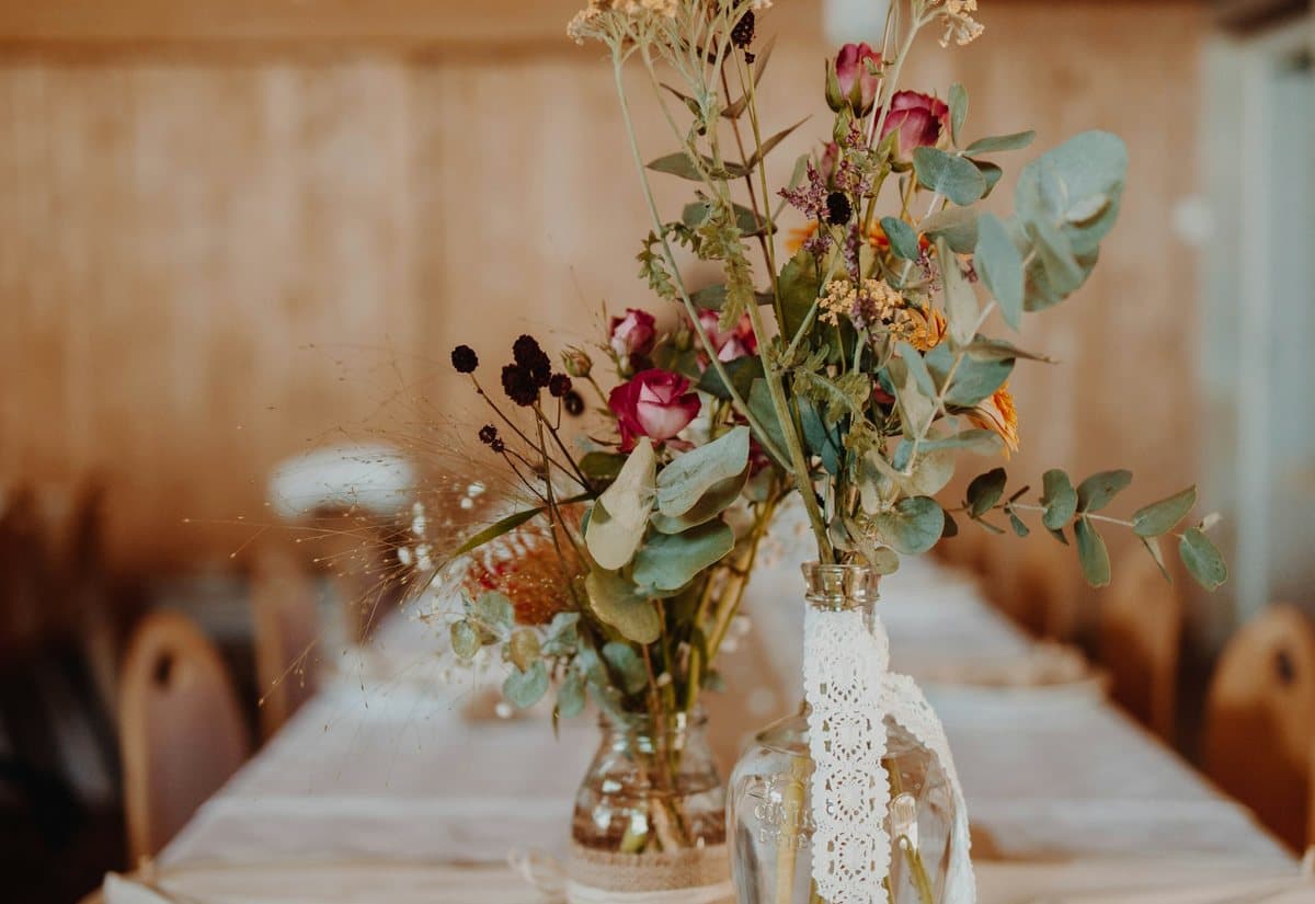 Wildflower arrangements on a rustic wedding table
